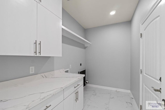 clothes washing area with cabinets and electric dryer hookup