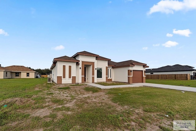 view of front facade with a garage and a front yard