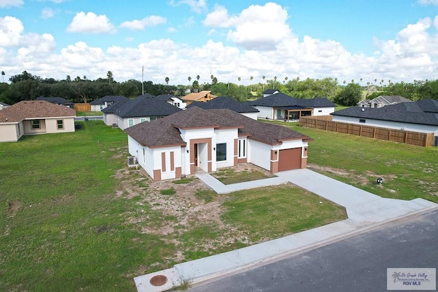 view of front of home featuring a garage and a front lawn