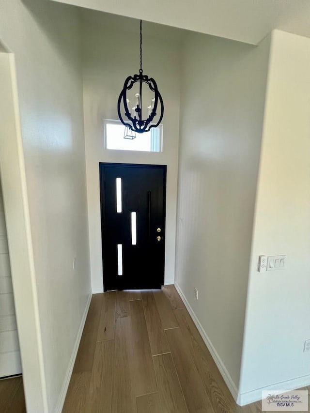 foyer entrance featuring wood finished floors and baseboards