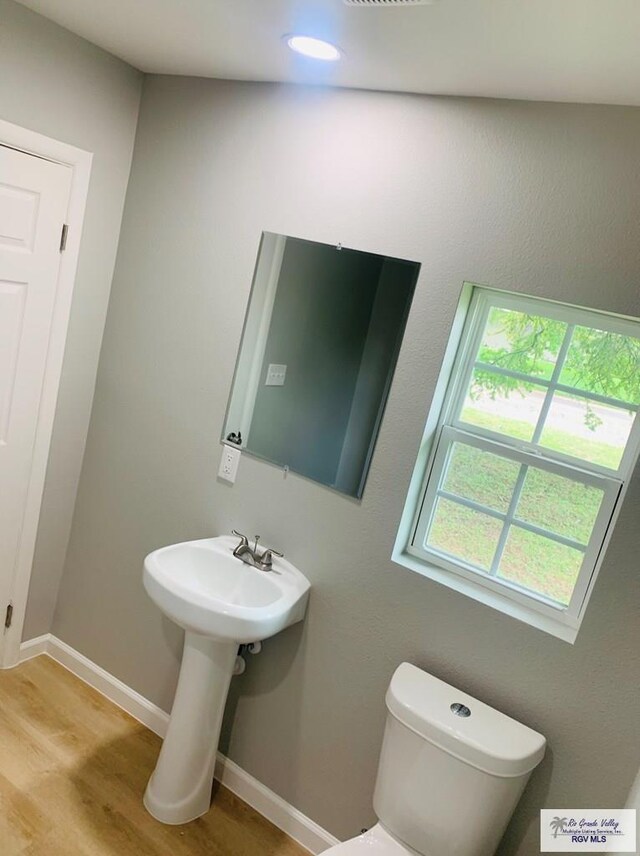 bathroom featuring hardwood / wood-style floors and toilet