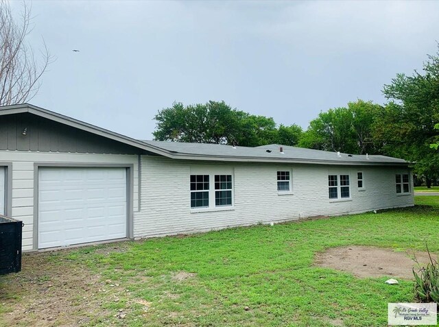 view of property exterior featuring a lawn and a garage