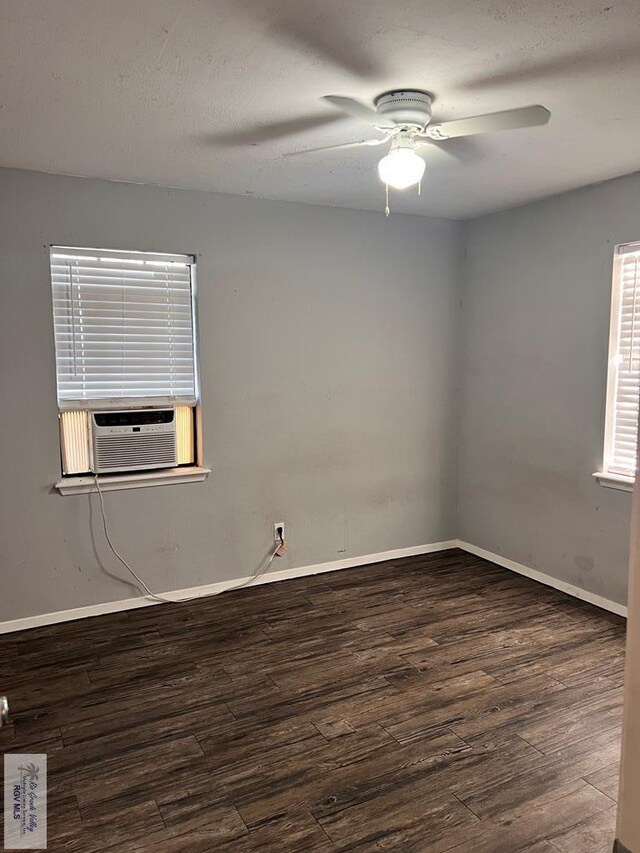 unfurnished room with ceiling fan and dark hardwood / wood-style flooring