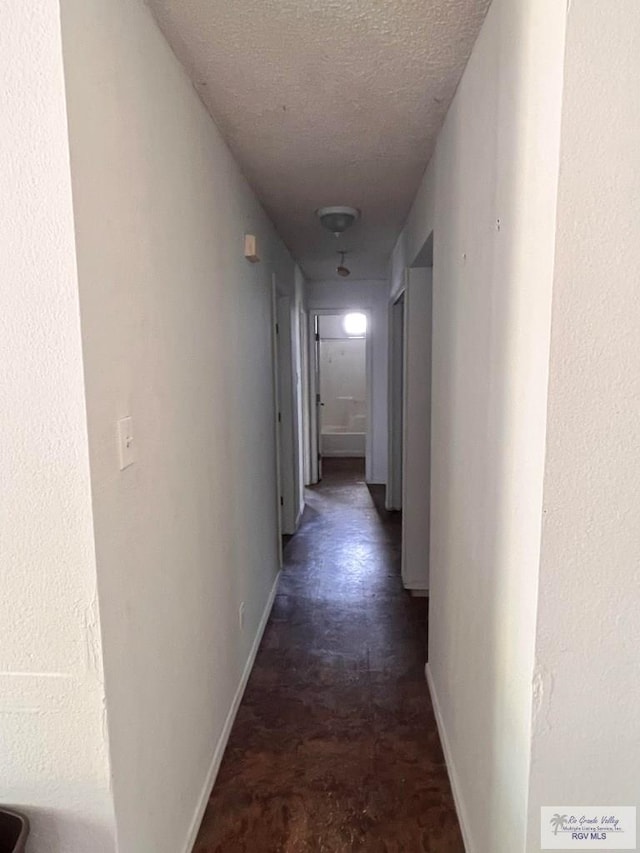 hallway featuring a textured ceiling