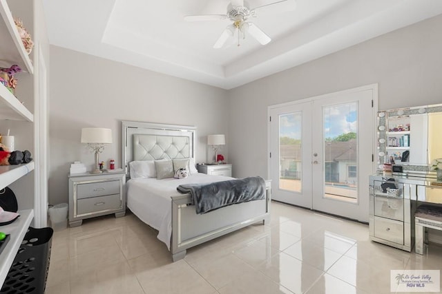 tiled bedroom featuring french doors, access to outside, a raised ceiling, and ceiling fan