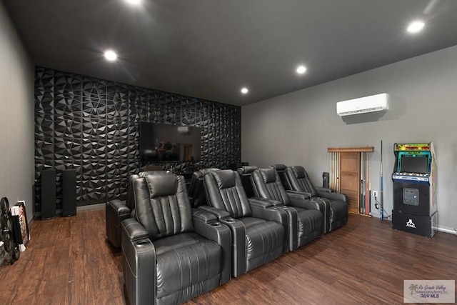 home theater room with an AC wall unit and dark wood-type flooring