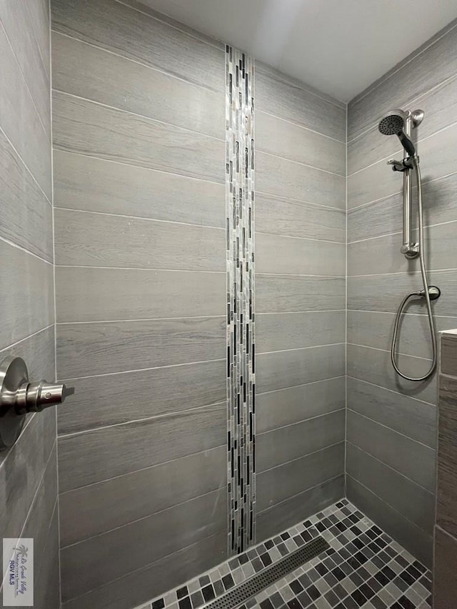 bathroom with tiled shower