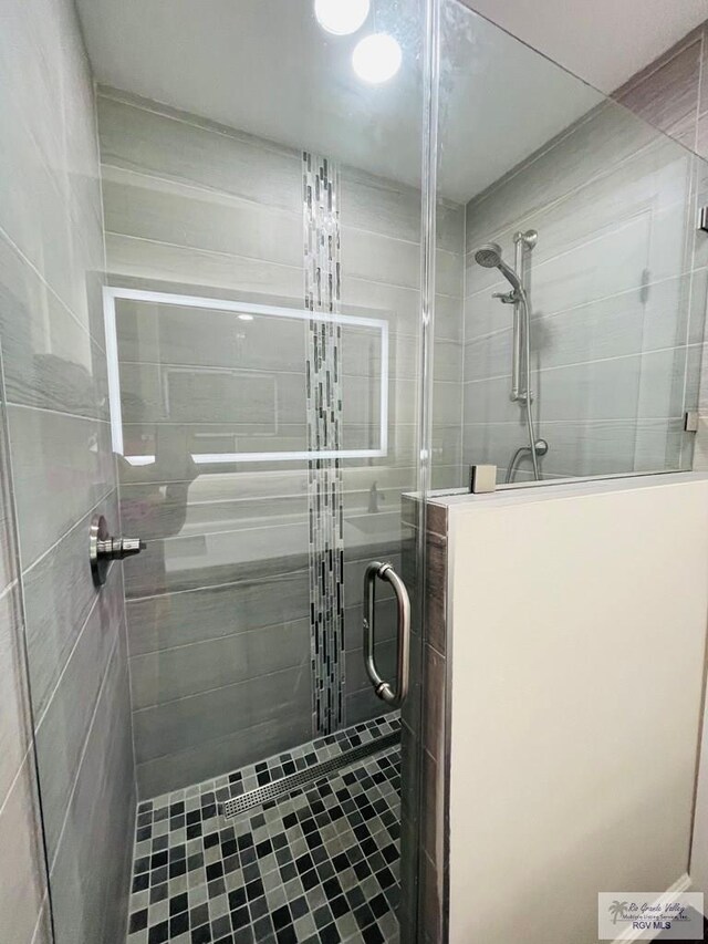 bathroom with a shower with shower door
