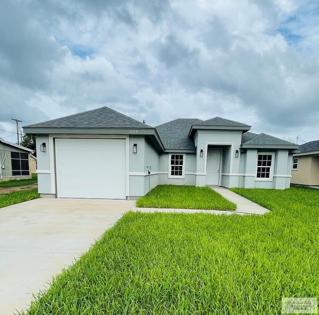 view of front of home with a garage and a front yard