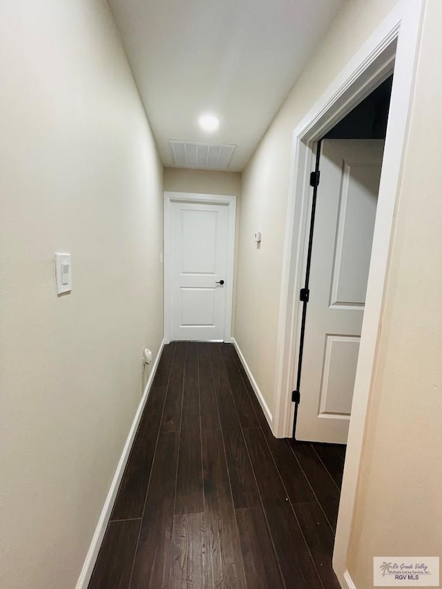 corridor with dark wood-type flooring