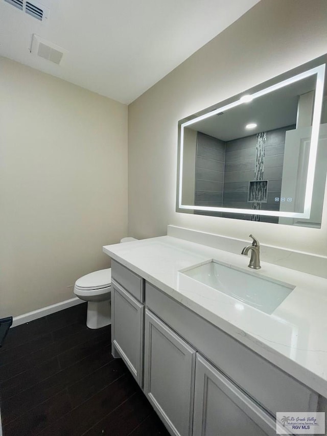 bathroom with a shower with shower curtain, vanity, toilet, and wood-type flooring