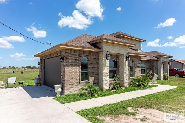 view of front of house with a front yard and a garage