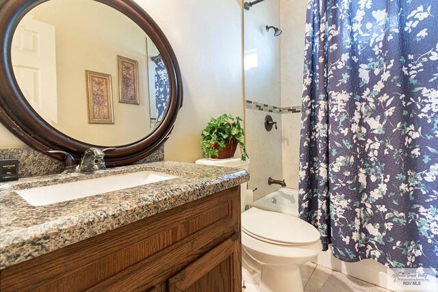 bathroom featuring tile patterned floors, vanity, and toilet