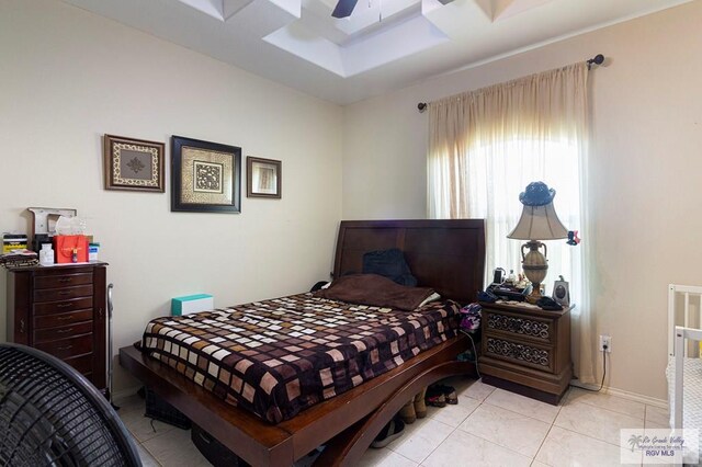 tiled bedroom featuring ceiling fan