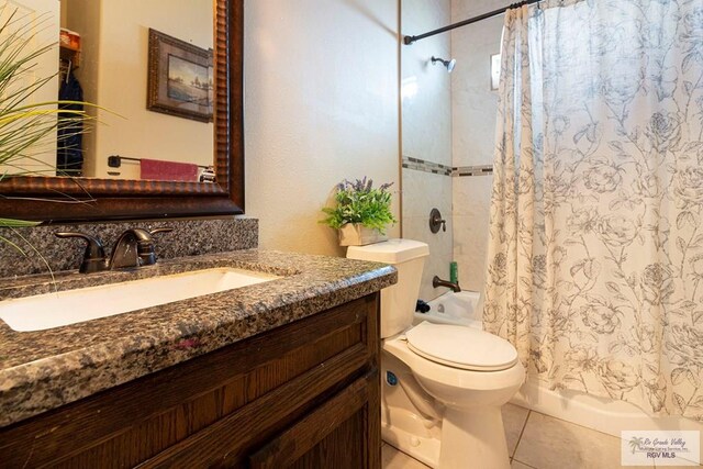 bathroom with tile patterned flooring, vanity, and toilet