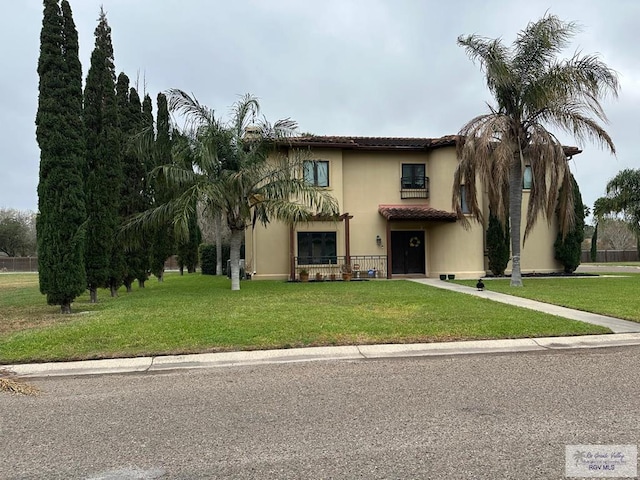 mediterranean / spanish-style house featuring stucco siding and a front yard