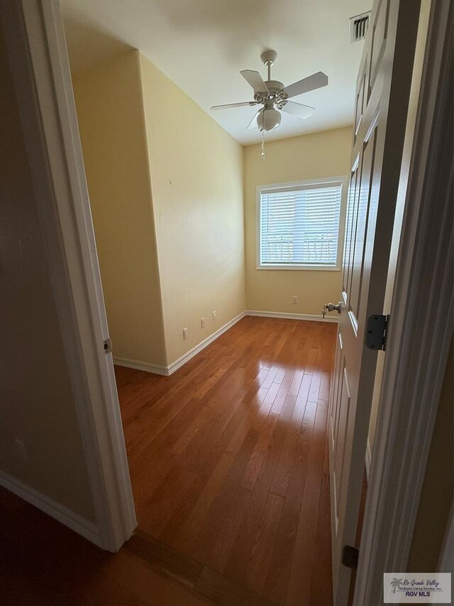 117 Palm Valley Cir, Harlingen, TX 78552 - unfurnished room featuring hardwood / wood-style floors, a ceiling fan, and baseboards