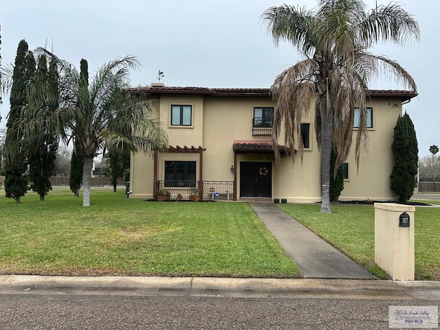 mediterranean / spanish home with a front lawn and stucco siding