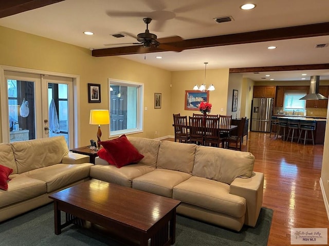 living room with french doors, dark wood-style flooring, recessed lighting, visible vents, and beamed ceiling