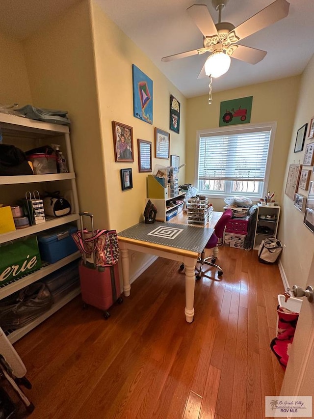 office with ceiling fan, baseboards, and wood finished floors