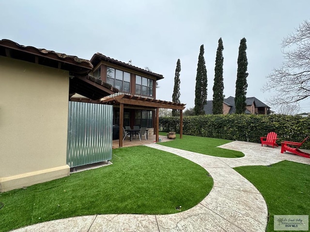 view of yard with a patio, fence, and a pergola