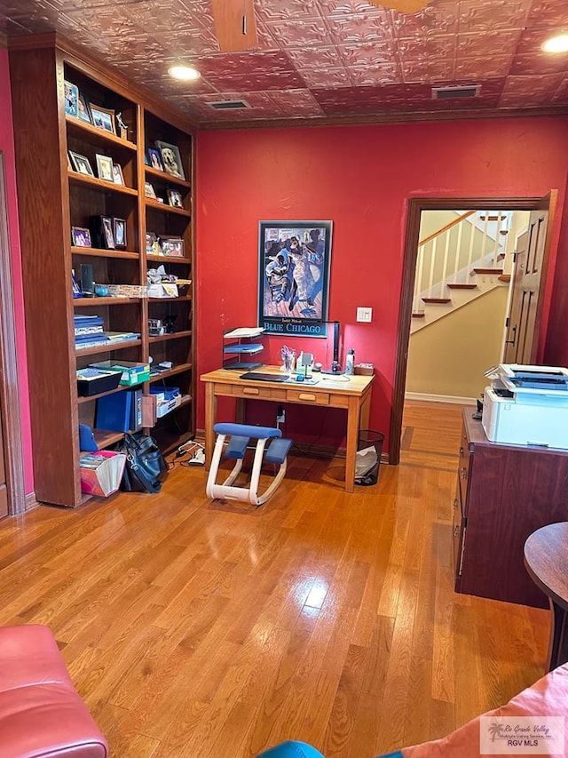 office space featuring an ornate ceiling, visible vents, and wood finished floors