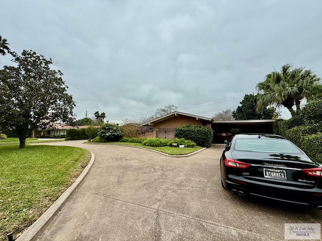 view of side of property with a carport and a yard