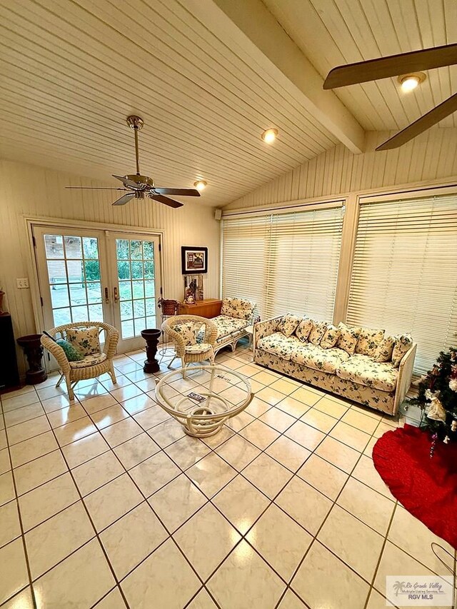 unfurnished living room featuring french doors, vaulted ceiling with beams, wood walls, wooden ceiling, and light tile patterned floors