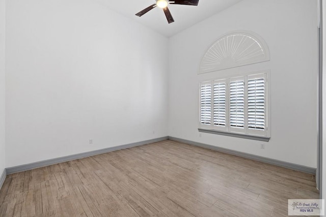 spare room with lofted ceiling, ceiling fan, and light wood-type flooring