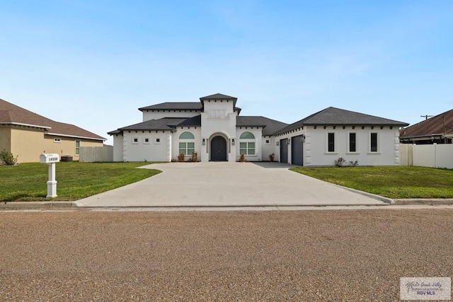 view of front of house featuring a garage and a front lawn