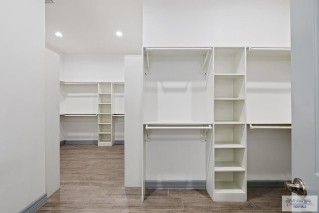 spacious closet featuring hardwood / wood-style flooring