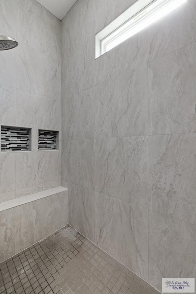 bathroom with tiled shower