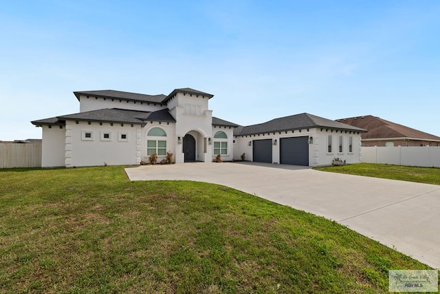 mediterranean / spanish home featuring a garage and a front yard