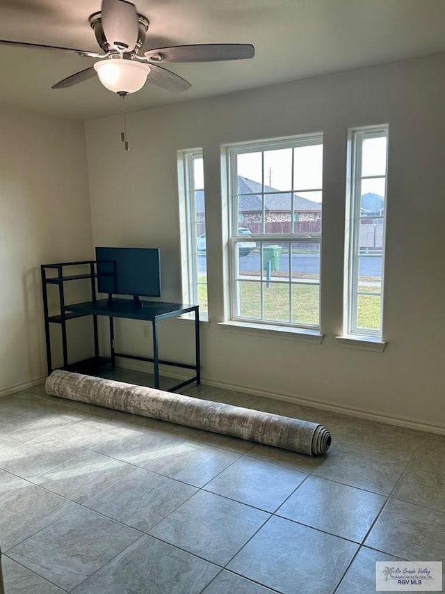 unfurnished bedroom with light tile patterned floors and ceiling fan