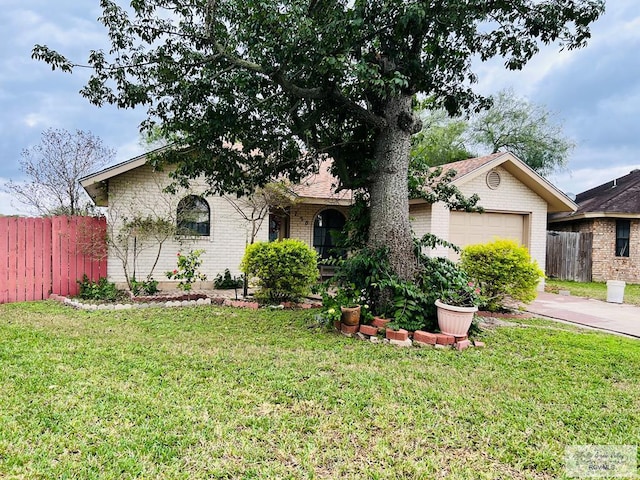 ranch-style house with a garage and a front lawn