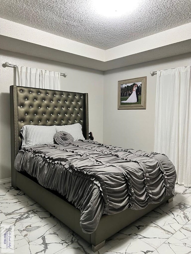 bedroom featuring a textured ceiling