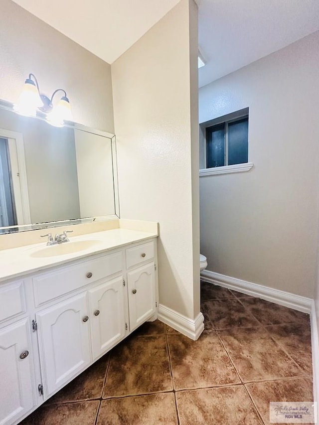 2200 E 19th St, Mission, TX 78572 - bathroom featuring tile patterned flooring, vanity, toilet, and baseboards