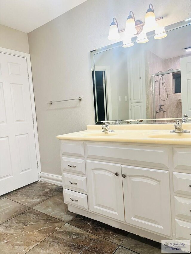 2200 E 19th St, Mission, TX 78572 - full bath featuring a shower stall, double vanity, and baseboards