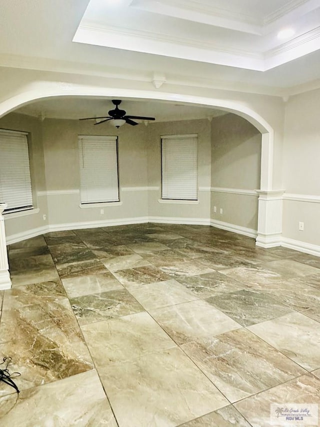 2200 E 19th St, Mission, TX 78572 - unfurnished room featuring a raised ceiling, arched walkways, crown molding, marble finish floors, and baseboards