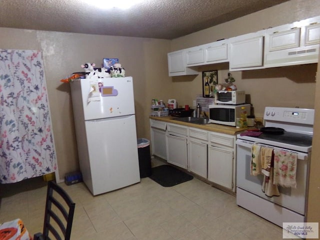 kitchen featuring white cabinets, sink, white appliances, and a textured ceiling