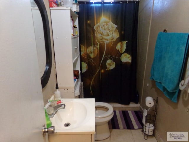 bathroom with tile patterned floors, vanity, curtained shower, and toilet