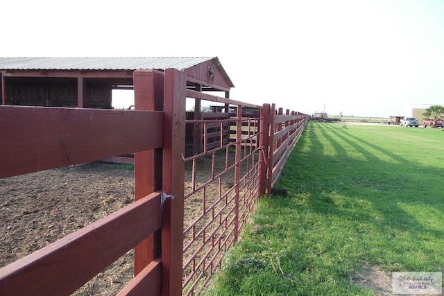 view of yard with an outbuilding and a rural view