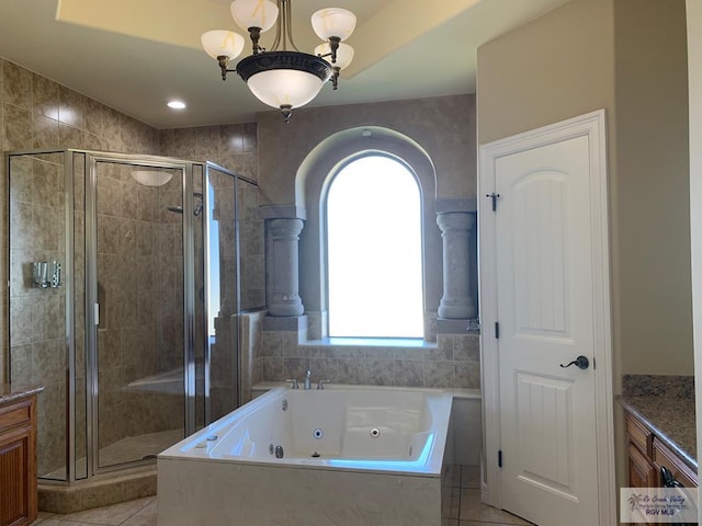 bathroom with tile patterned floors, vanity, separate shower and tub, and a chandelier