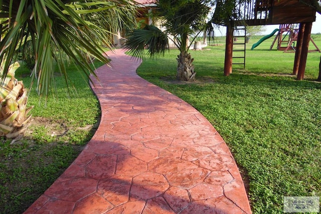 view of community featuring a playground and a yard