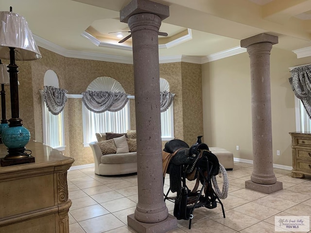 tiled living room with ornamental molding, a tray ceiling, and decorative columns