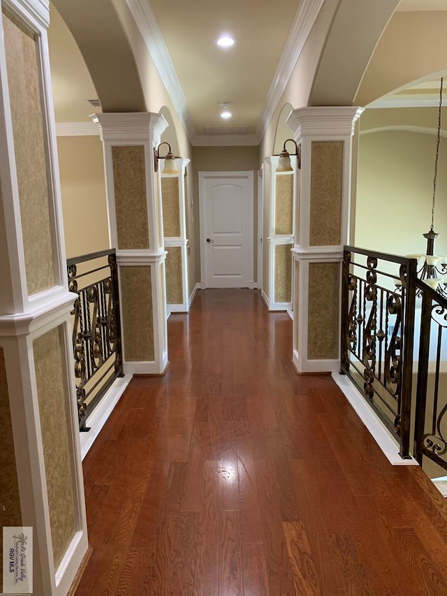 corridor with ornamental molding and dark wood-type flooring