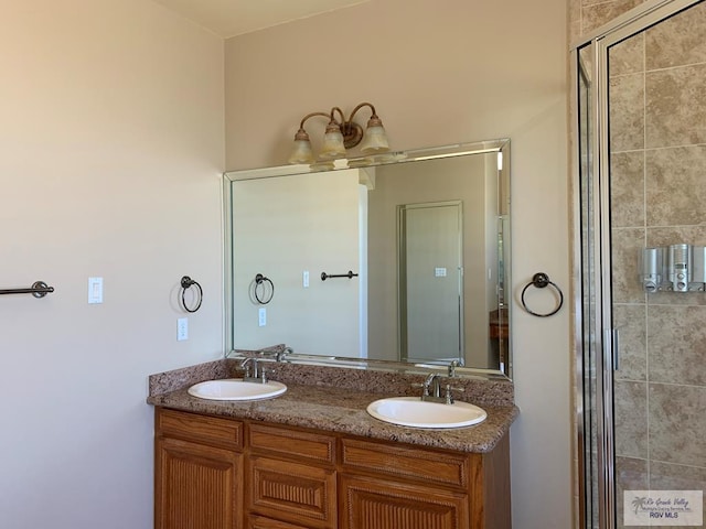 bathroom featuring vanity and a shower with shower door