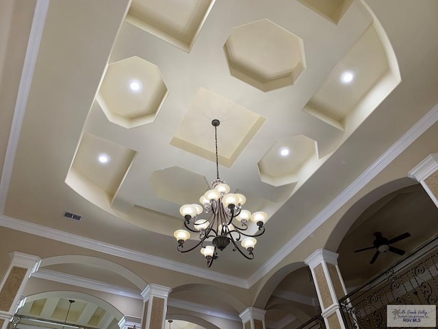 interior details with ceiling fan with notable chandelier, ornate columns, and crown molding