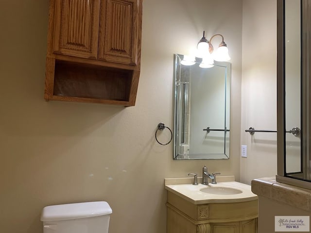 bathroom featuring vanity and toilet