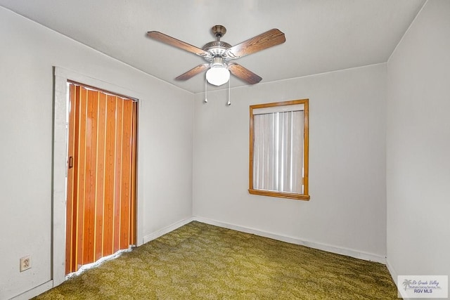 carpeted empty room featuring ceiling fan